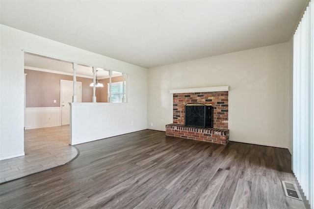 4333 NW 55th St, Oklahoma City, OK 73112 - unfurnished living room with wood finished floors, a chandelier, a fireplace, and baseboards