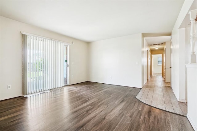 4333 NW 55th St, Oklahoma City, OK 73112 - unfurnished room with wood finished floors, plenty of natural light, and baseboards