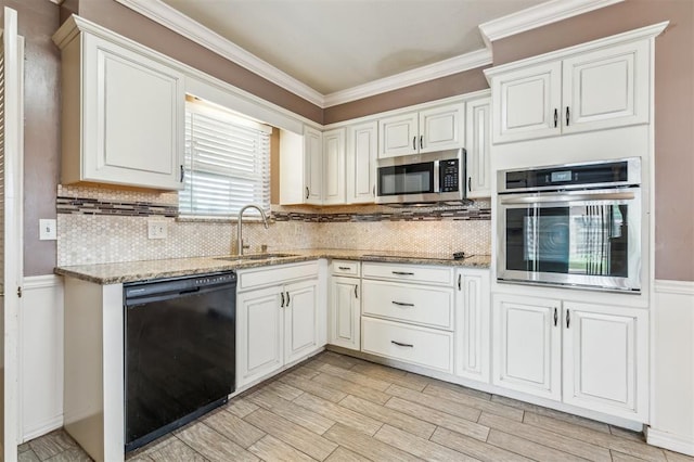 4333 NW 55th St, Oklahoma City, OK 73112 - kitchen featuring black appliances, a sink, crown molding, backsplash, and light stone countertops