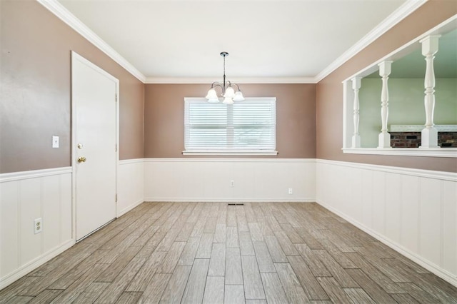4333 NW 55th St, Oklahoma City, OK 73112 - unfurnished room featuring wood finished floors, a chandelier, a wainscoted wall, and crown molding