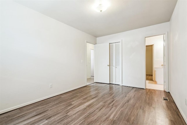 4333 NW 55th St, Oklahoma City, OK 73112 - unfurnished bedroom with wood finished floors, a closet, and baseboards