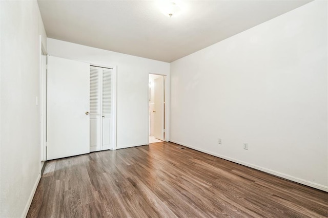 4333 NW 55th St, Oklahoma City, OK 73112 - unfurnished bedroom featuring wood finished floors, baseboards, and a closet