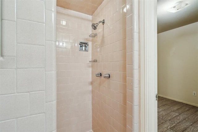4333 NW 55th St, Oklahoma City, OK 73112 - bathroom with tiled shower, baseboards, and wood finished floors