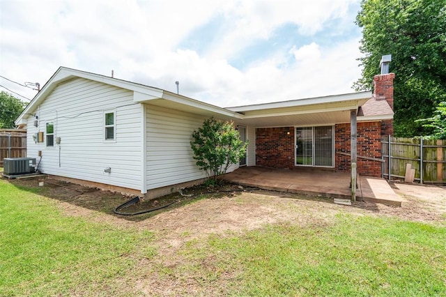 4333 NW 55th St, Oklahoma City, OK 73112 - rear view of property featuring cooling unit, a chimney, a patio area, and brick siding