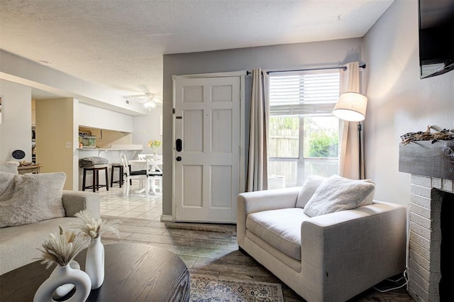 809 Cardinal Creek Blvd, Norman, OK 73072 - living room featuring a ceiling fan, wood finished floors, and a fireplace