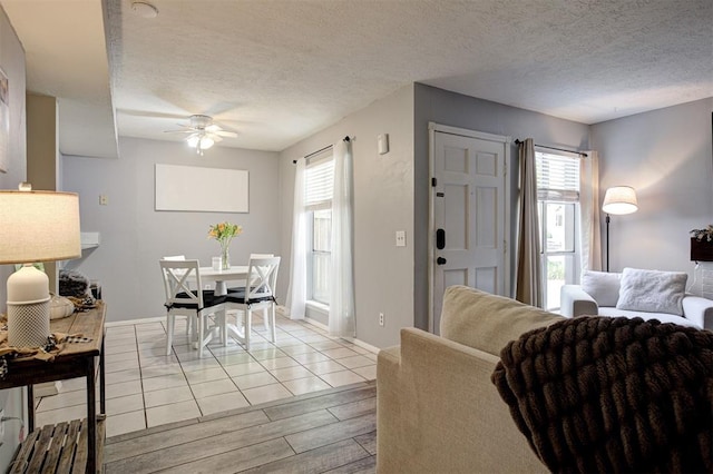 809 Cardinal Creek Blvd, Norman, OK 73072 - living area featuring a ceiling fan, a textured ceiling, light wood-style floors, and baseboards