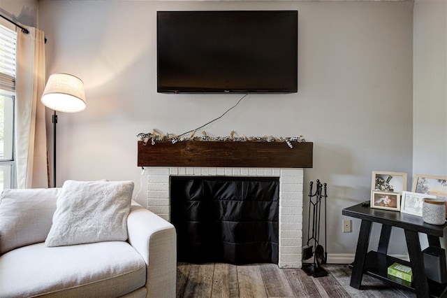 809 Cardinal Creek Blvd, Norman, OK 73072 - living room with wood finished floors, a brick fireplace, and baseboards