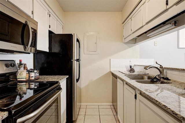 809 Cardinal Creek Blvd, Norman, OK 73072 - kitchen featuring appliances with stainless steel finishes, a sink, decorative backsplash, and electric panel
