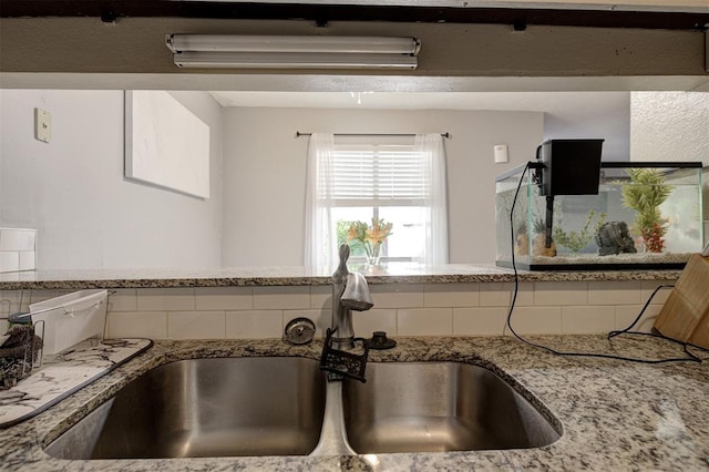 809 Cardinal Creek Blvd, Norman, OK 73072 - kitchen view of a sink, tasteful backsplash, and light stone countertops