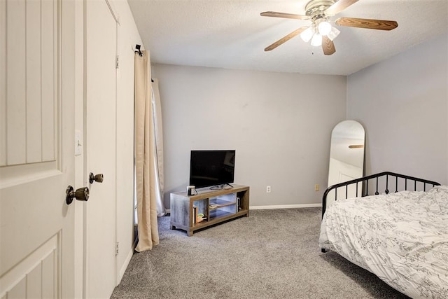809 Cardinal Creek Blvd, Norman, OK 73072 - carpeted bedroom with a textured ceiling, ceiling fan, and baseboards
