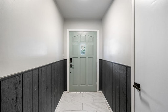 16 Clark Cir, Shawnee, OK 74804 - doorway with wainscoting, wood walls, and light marble finish floors