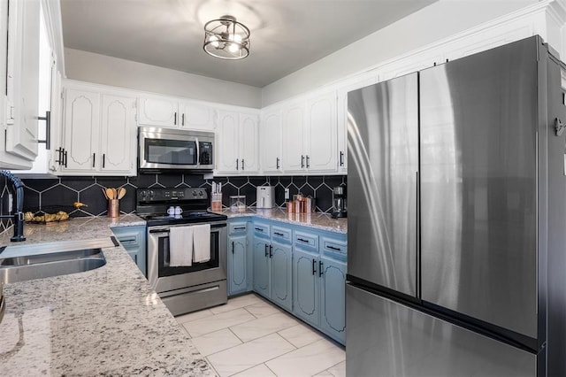 16 Clark Cir, Shawnee, OK 74804 - kitchen featuring appliances with stainless steel finishes, a sink, white cabinetry, and light marble finish floors