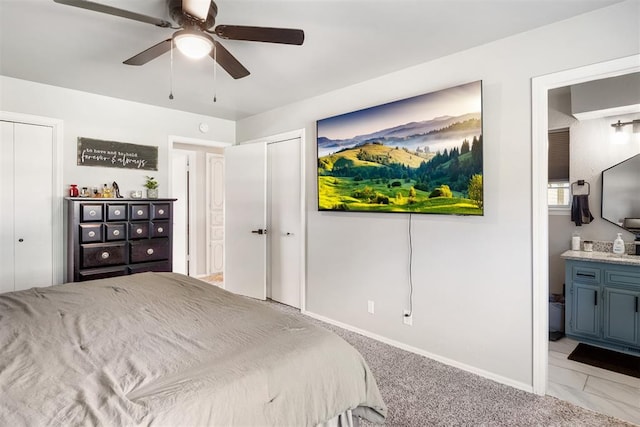 16 Clark Cir, Shawnee, OK 74804 - bedroom with two closets, connected bathroom, baseboards, light colored carpet, and ceiling fan