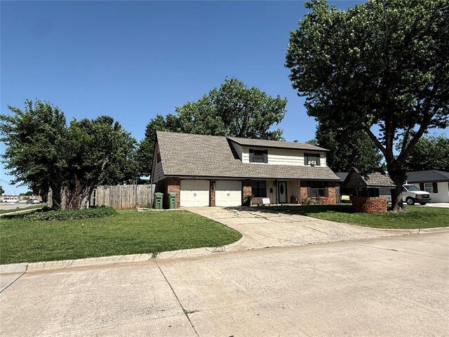 1000 Winnipeg Dr, Yukon, OK 73099 - traditional-style home featuring brick siding, an attached garage, and driveway