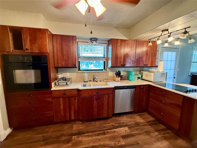 1000 Winnipeg Dr, Yukon, OK 73099 - kitchen featuring black appliances, a sink, light countertops, and dark wood-style flooring