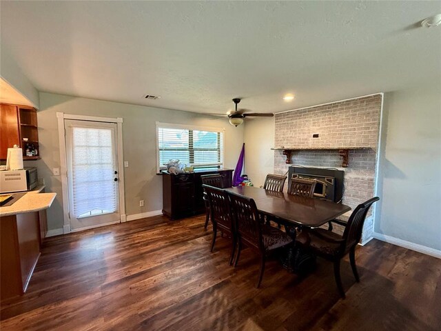 1000 Winnipeg Dr, Yukon, OK 73099 - dining room featuring ceiling fan, dark wood-style floors, a fireplace, and baseboards
