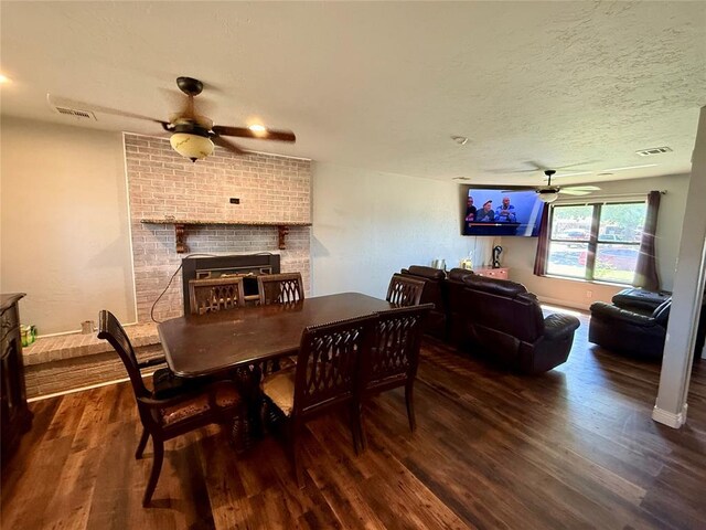 1000 Winnipeg Dr, Yukon, OK 73099 - dining area with a ceiling fan, wood finished floors, a brick fireplace, a textured ceiling, and baseboards