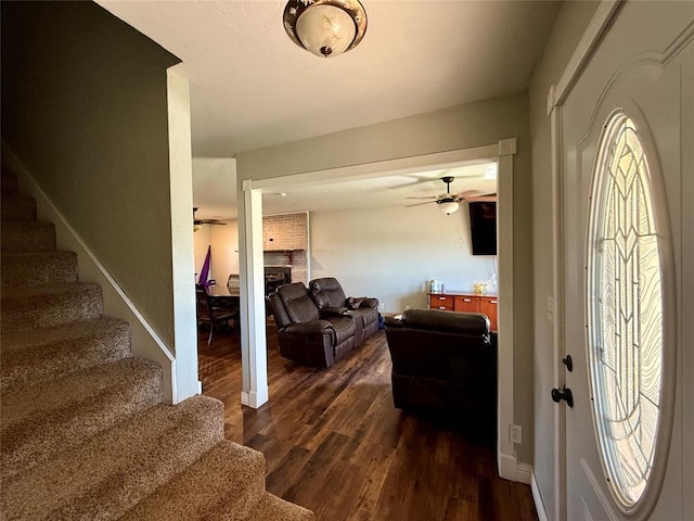 1000 Winnipeg Dr, Yukon, OK 73099 - foyer with a ceiling fan, stairway, a brick fireplace, and dark wood-style flooring