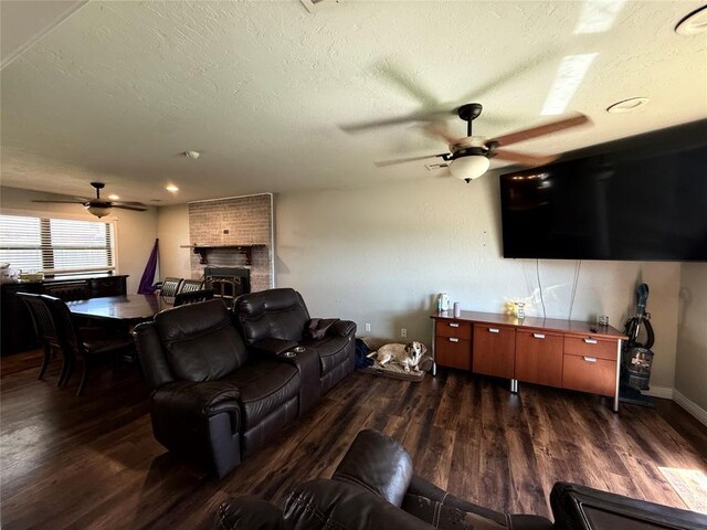 1000 Winnipeg Dr, Yukon, OK 73099 - living area with ceiling fan, wood finished floors, a textured ceiling, and a brick fireplace