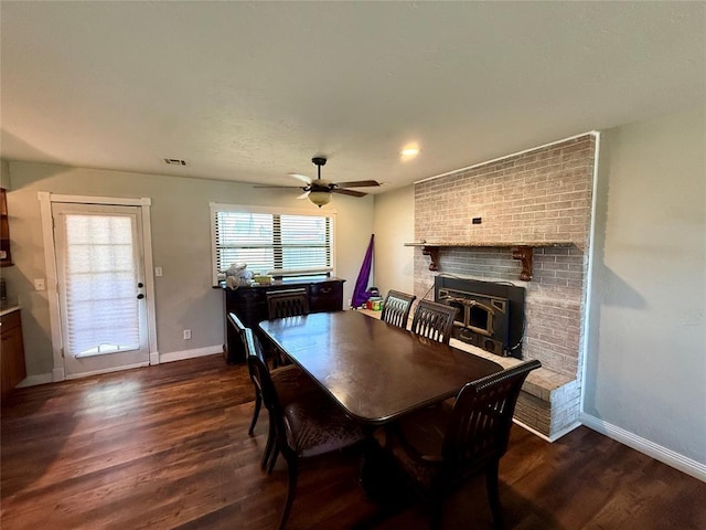 1000 Winnipeg Dr, Yukon, OK 73099 - dining space with baseboards, dark wood finished floors, a ceiling fan, and a fireplace