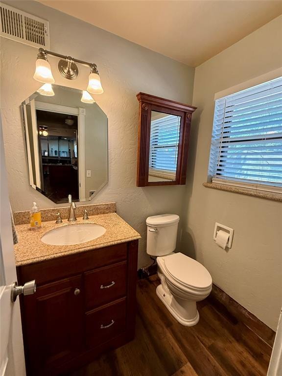 1000 Winnipeg Dr, Yukon, OK 73099 - half bath with wood finished floors, toilet, and vanity