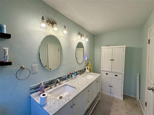 1000 Winnipeg Dr, Yukon, OK 73099 - full bathroom featuring double vanity, a textured ceiling, and baseboards