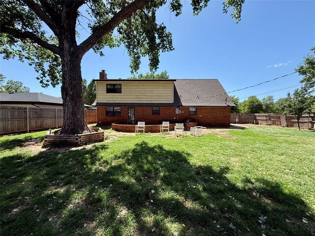 1000 Winnipeg Dr, Yukon, OK 73099 - rear view of house featuring a chimney and brick siding