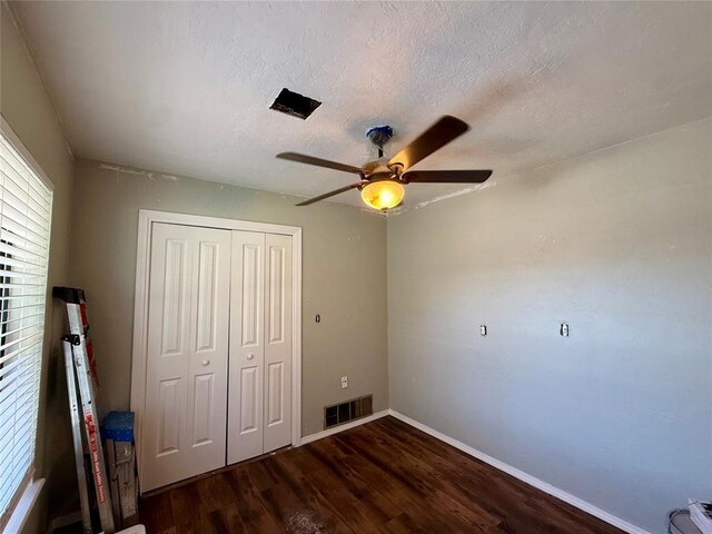 1000 Winnipeg Dr, Yukon, OK 73099 - unfurnished bedroom featuring wood finished floors, a closet, baseboards, a textured ceiling, and a ceiling fan