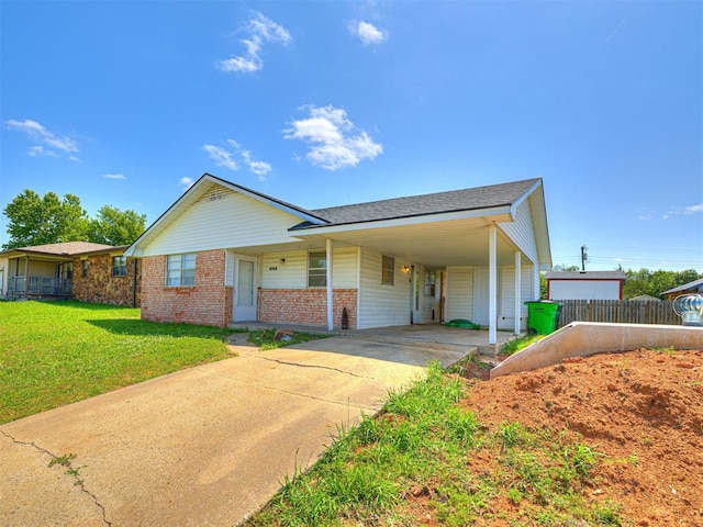 1810 Haynie Ln, Prague, OK 74864 - view of front of house with driveway, brick siding, and a carport