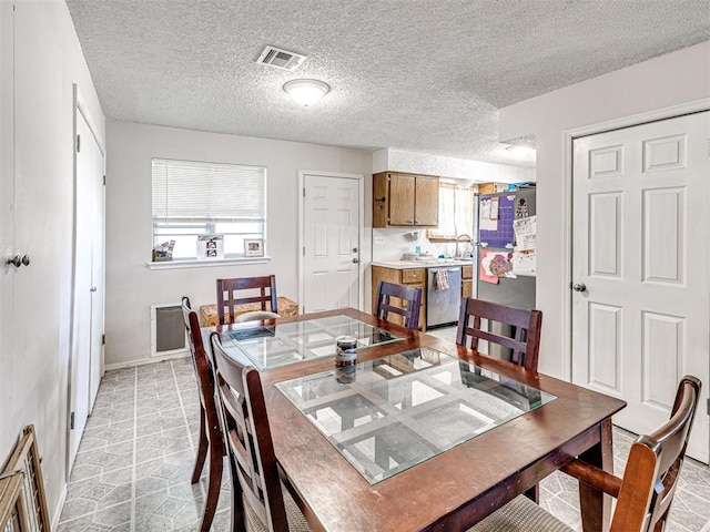 1810 Haynie Ln, Prague, OK 74864 - dining room featuring plenty of natural light, baseboards, and a textured ceiling