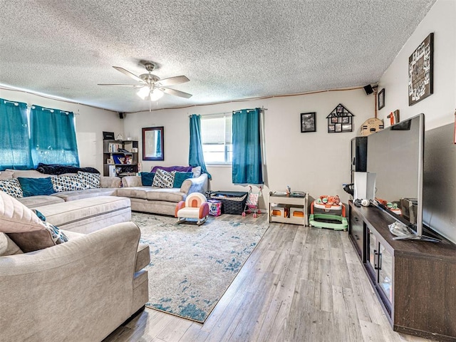 1810 Haynie Ln, Prague, OK 74864 - living room featuring a ceiling fan, light wood finished floors, and a textured ceiling