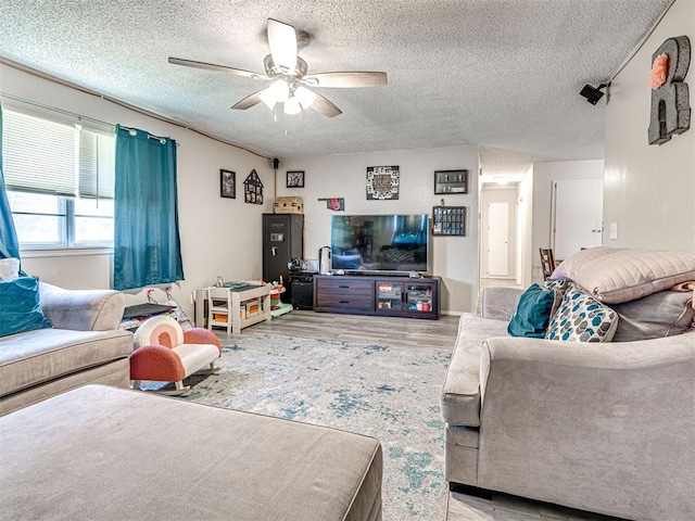 1810 Haynie Ln, Prague, OK 74864 - living room with a ceiling fan, a textured ceiling, and wood finished floors