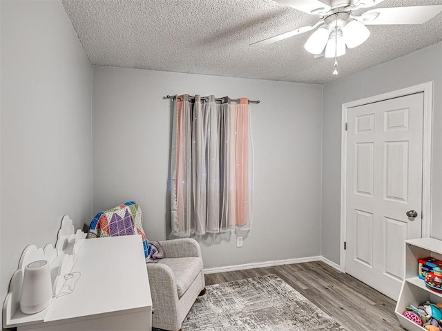 1810 Haynie Ln, Prague, OK 74864 - sitting room with wood finished floors, ceiling fan, and a textured ceiling
