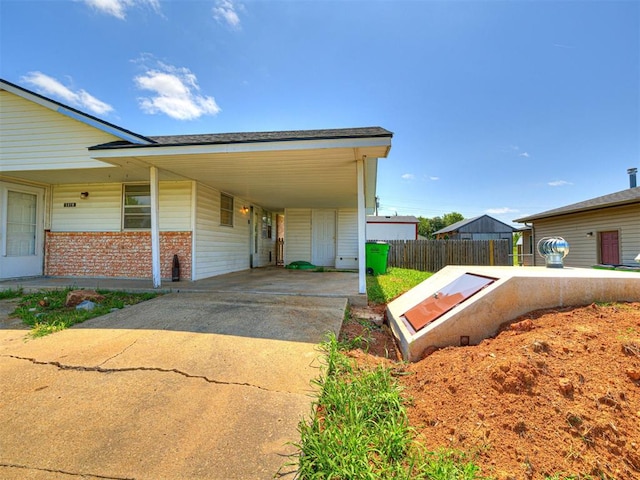 1810 Haynie Ln, Prague, OK 74864 - view of front of house with concrete driveway, brick siding, and an attached carport