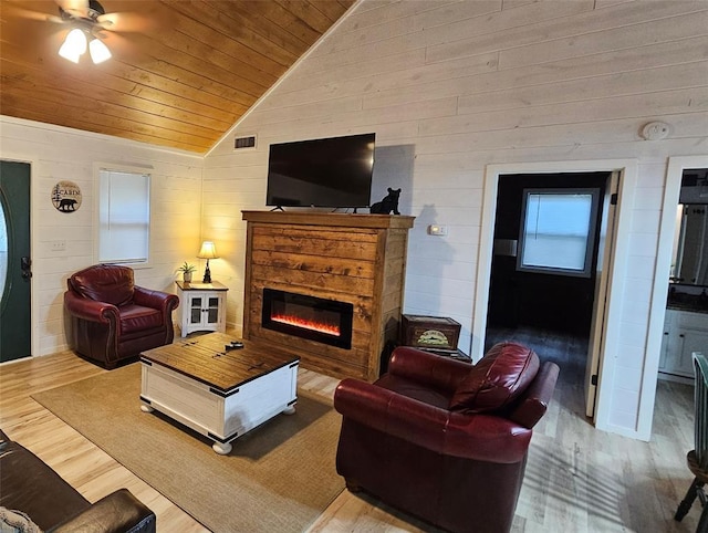 178 Marlin Dr, Broken Bow, OK 74728 - living room with wood ceiling, vaulted ceiling, wood walls, wood finished floors, and a glass covered fireplace