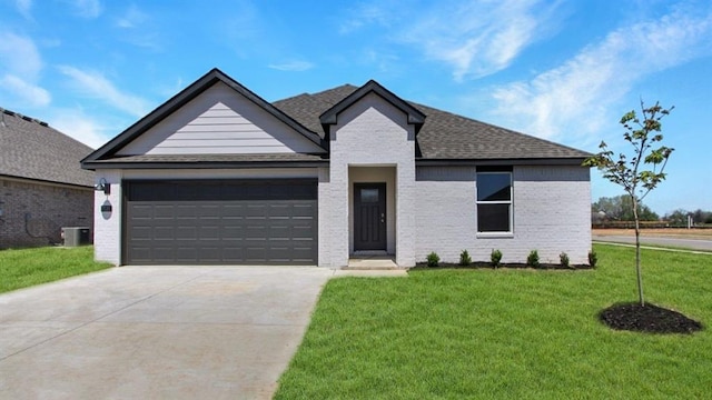 9112 NW 149th St, Yukon, OK 73099 - view of front of property featuring driveway, an attached garage, a front lawn, roof with shingles, and brick siding