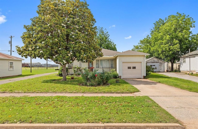 111 W Colorado Ave, Okarche, OK 73762 - view of front of property with a front yard, driveway, an attached garage, and roof with shingles