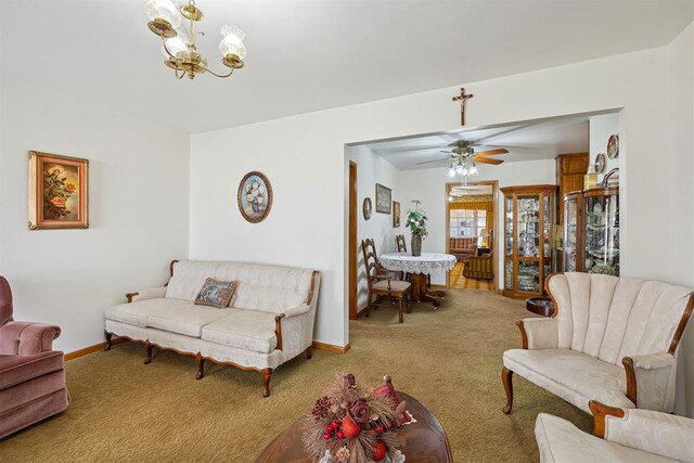 111 W Colorado Ave, Okarche, OK 73762 - living area featuring a chandelier, carpet flooring, baseboards, and ceiling fan