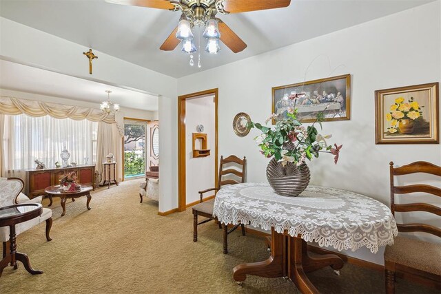 111 W Colorado Ave, Okarche, OK 73762 - carpeted dining area featuring a ceiling fan, a chandelier, and baseboards