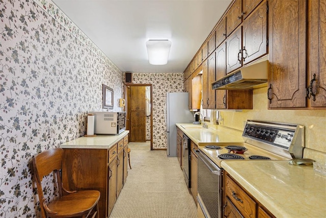111 W Colorado Ave, Okarche, OK 73762 - kitchen featuring range with electric stovetop, wallpapered walls, under cabinet range hood, black dishwasher, and light countertops