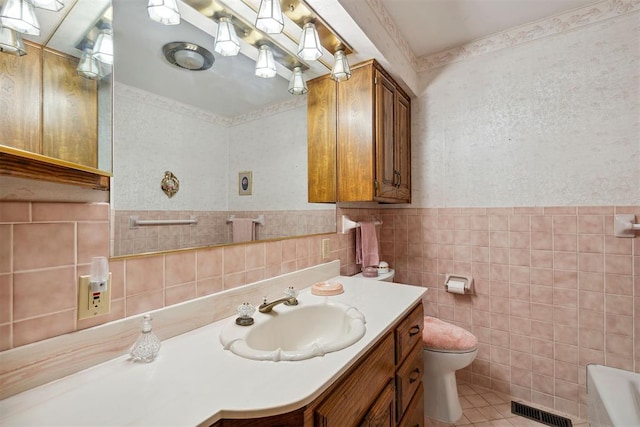 111 W Colorado Ave, Okarche, OK 73762 - full bathroom featuring toilet, tile walls, a bathtub, vanity, and tile patterned flooring