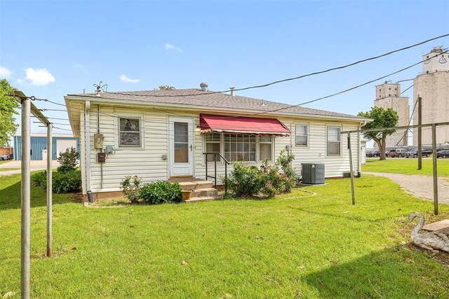 111 W Colorado Ave, Okarche, OK 73762 - back of property featuring central AC and a lawn