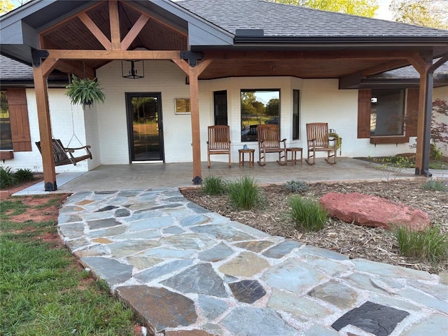 11790 E Etowah Rd, Noble, OK 73068 - view of exterior entry featuring a shingled roof and a patio area