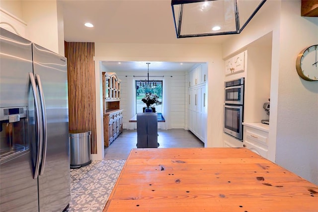 11790 E Etowah Rd, Noble, OK 73068 - kitchen with stainless steel appliances, wood finished floors, recessed lighting, white cabinets, and pendant lighting