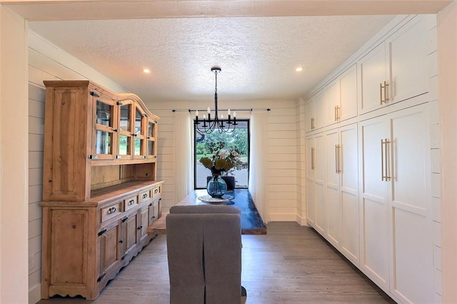 11790 E Etowah Rd, Noble, OK 73068 - dining room featuring a chandelier, light wood finished floors, a textured ceiling, recessed lighting, and wooden walls