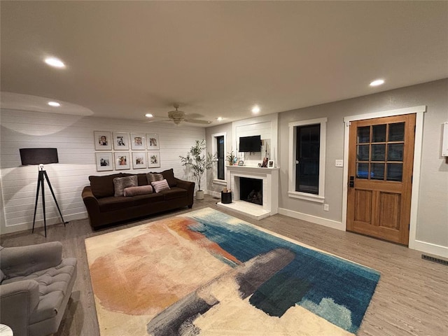 11790 E Etowah Rd, Noble, OK 73068 - living room featuring a fireplace with raised hearth, recessed lighting, wood finished floors, baseboards, and ceiling fan