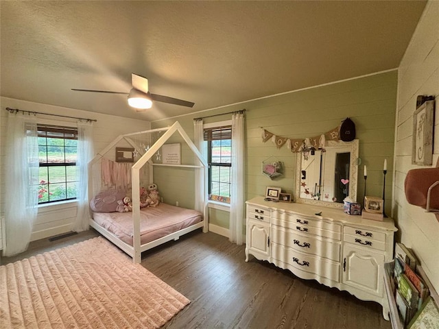 11790 E Etowah Rd, Noble, OK 73068 - bedroom featuring dark wood finished floors, multiple windows, ceiling fan, a textured ceiling, and baseboards