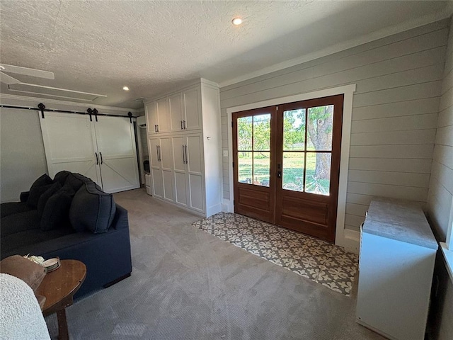 11790 E Etowah Rd, Noble, OK 73068 - foyer entrance featuring a barn door, french doors, a textured ceiling, light carpet, and recessed lighting