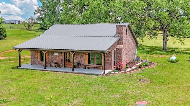 11790 E Etowah Rd, Noble, OK 73068 - back of property with a lawn, brick siding, a chimney, and central air condition unit