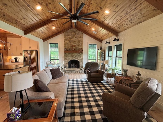 11790 E Etowah Rd, Noble, OK 73068 - living area with ceiling fan, wooden ceiling, a stone fireplace, and wood finished floors